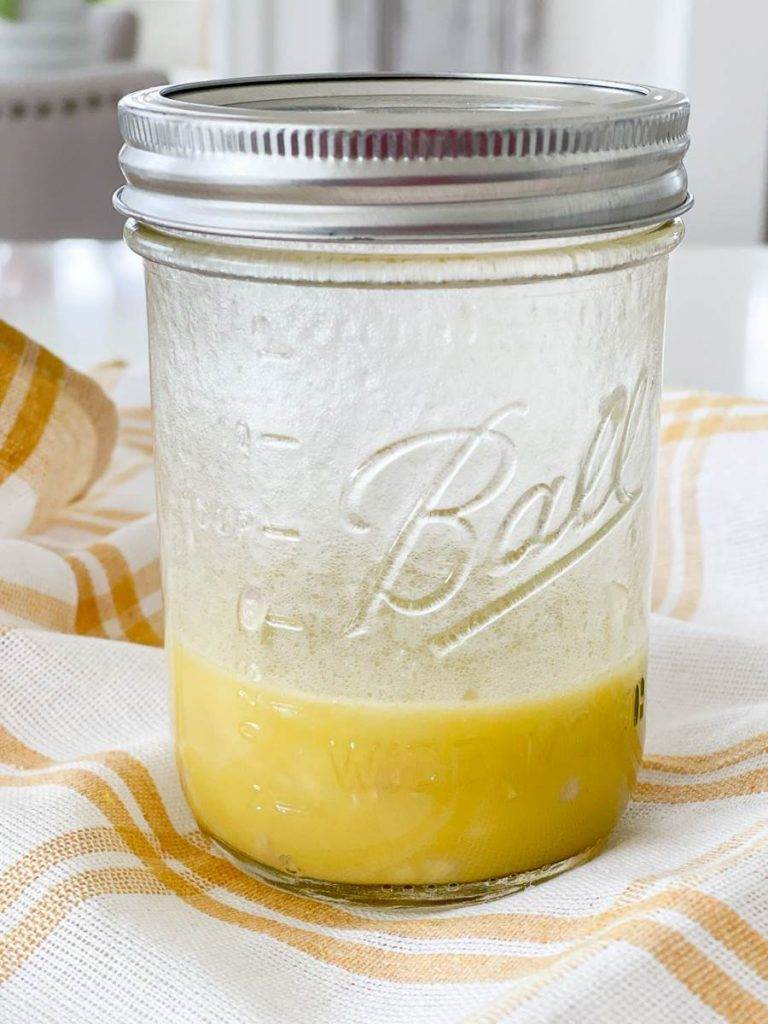 MASON JAR FILLED WITH LEMON VINAIGRETTE