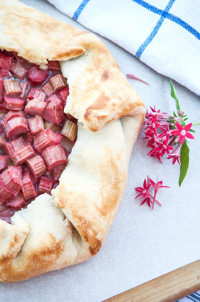 GALETTE ON A WORK SURFACE WITH A HOT PINK FLOWER