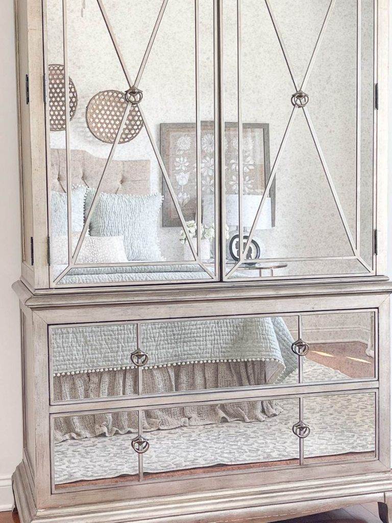 MIRRORED ARMOIRE IN A BEDROOM