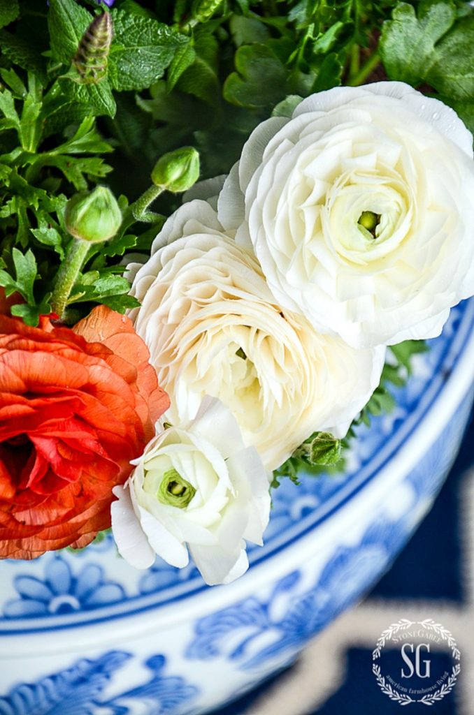 white and orange flowers in a porcelain container