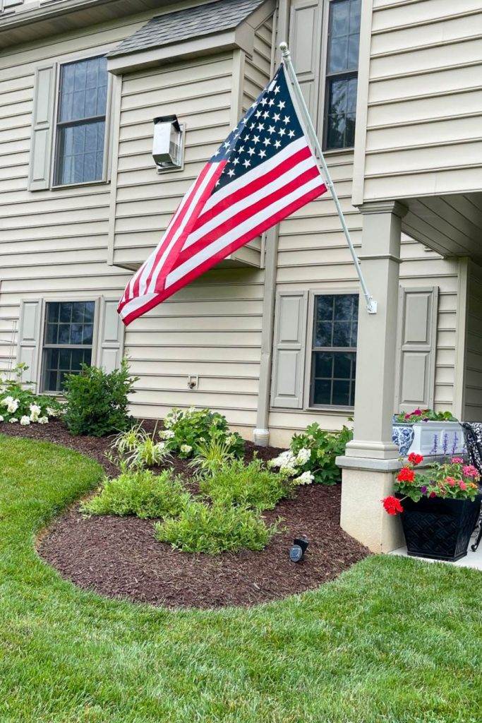 AMERICAN FLAG ON THE BACK OF A HOUSE