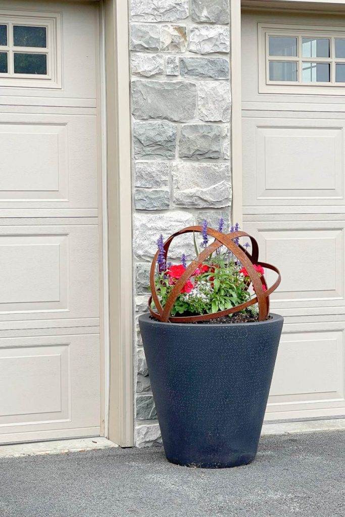 PLANTER OF SUMMER FLOWERS BETWEEN GARAGE DOORS