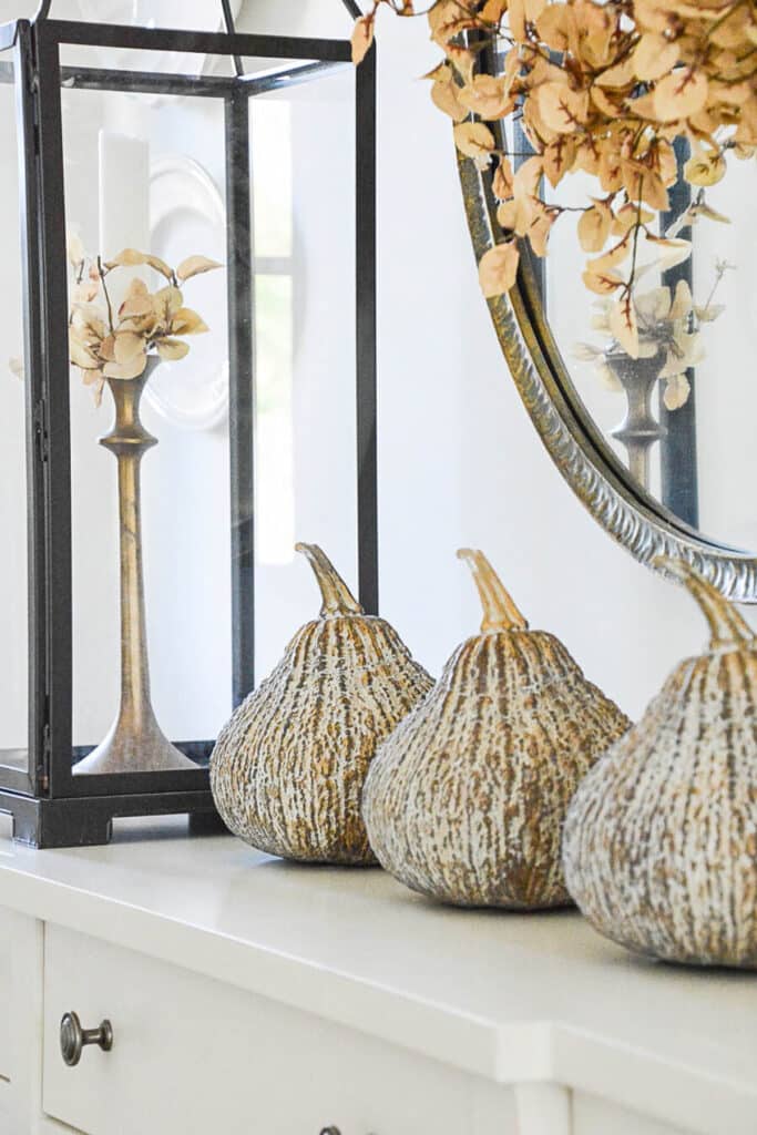 gold gourds on a console table