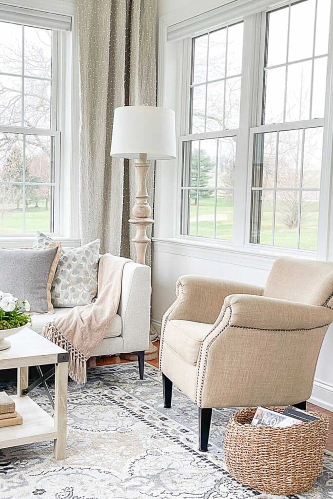 DECORATING WITH BOOKS- eclectic books in a basket near a chair