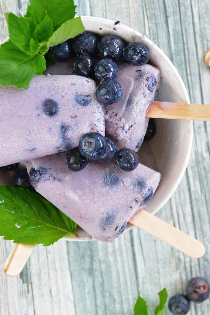 homemade blueberry popsicles in a bowl