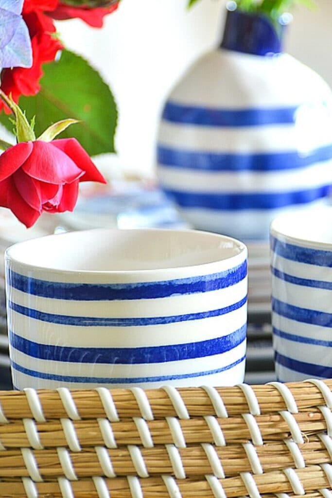 red, white and blue patriotic centerpiece in a basket with two small American flags