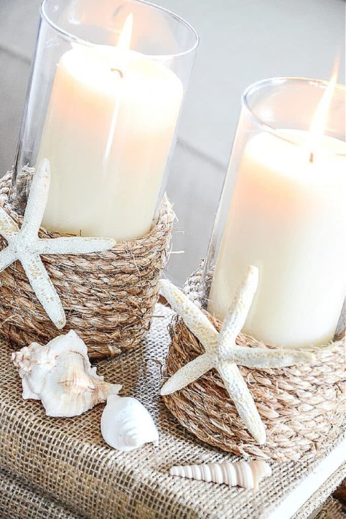 A PAIR OF ROPE WRAPPED DIY CANDLE HOLDER ON A STACK OF BOOKS