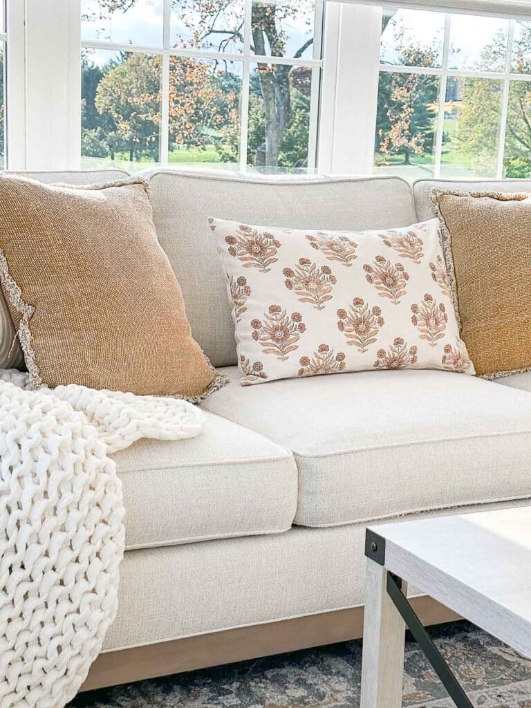 fall inspired lumbar pilllow on a sofa