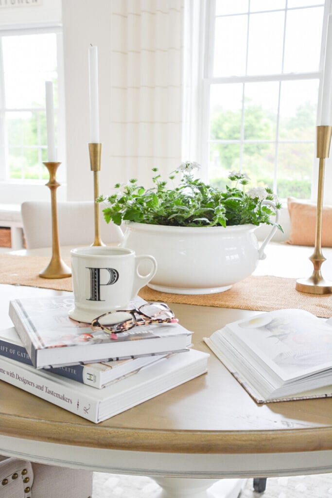 BOOKS AND A COFFEE MUG ON THE DINING ROOM TABLE