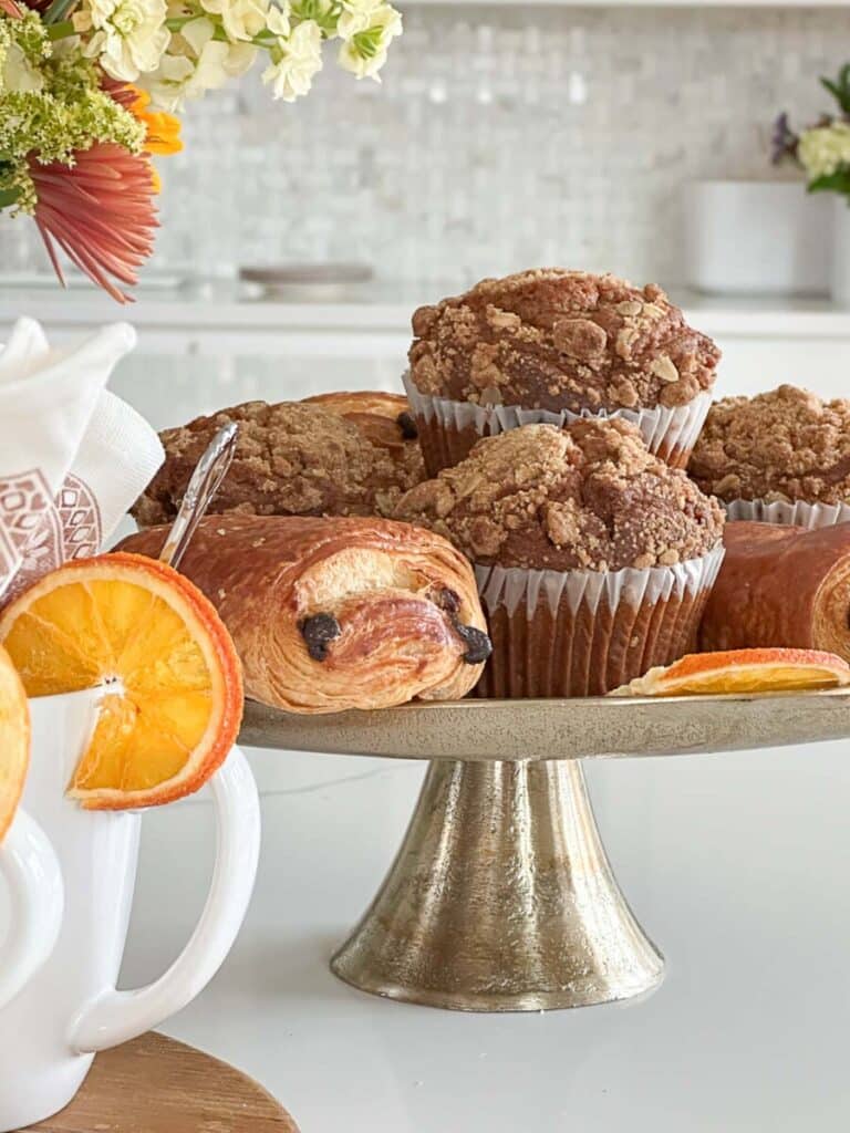 THANKSGIVING COFFEE BAR- mufins and chocolate croissants on a gold pedestal plate