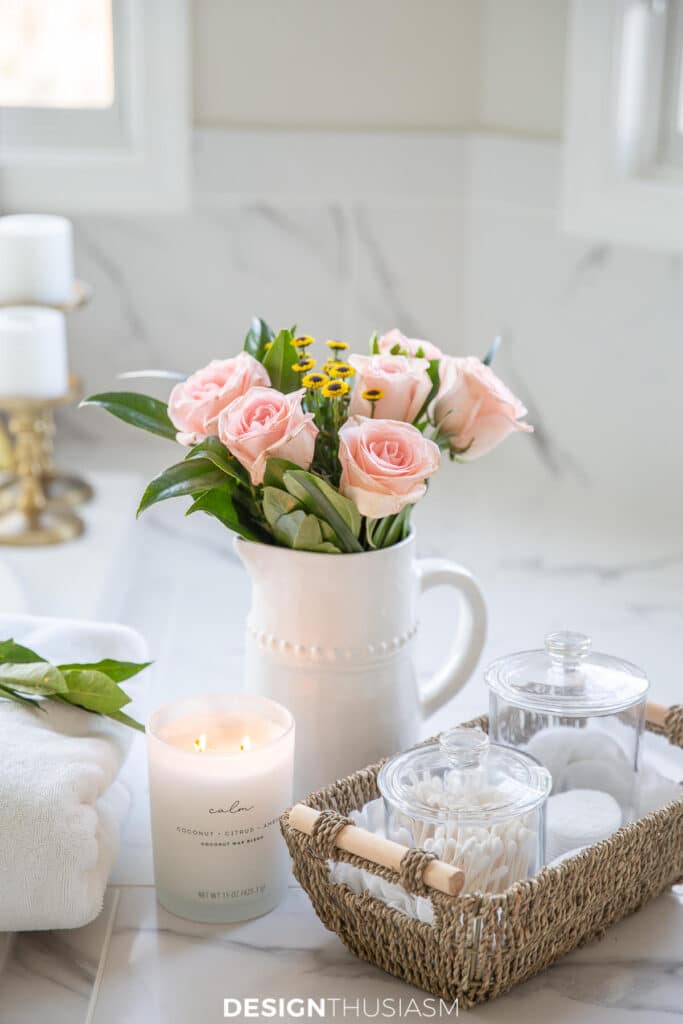 pitcher of pink roses and toilettries