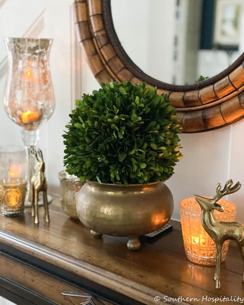 table with a mirror above it with winter decor